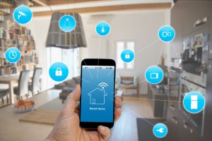 Hand holding smartphone with smart home application on screen iStock 1132781699