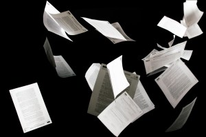 Many flying business documents isolated on black background Papers flying in air in business concept iStock 1205116067